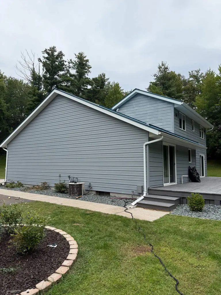 A vibrant magenta entry door complements the newly stained brown deck and lattice skirt, finished flawlessly by Texas Star Painting of Austin.