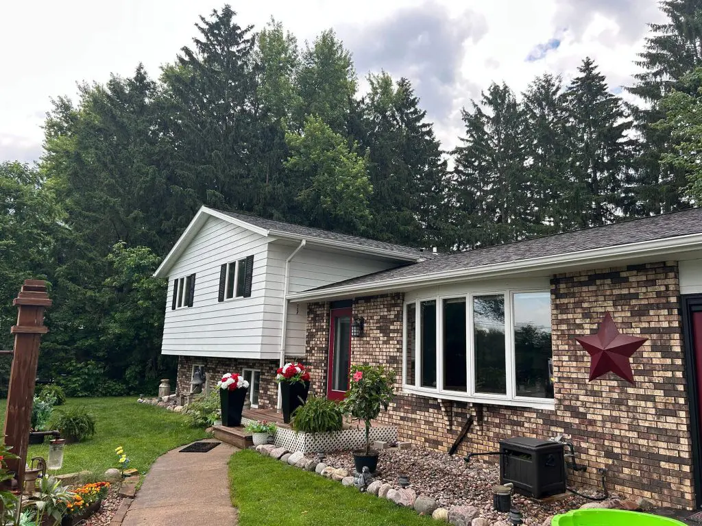 A beautiful blend of white siding and brick with striking curb appeal, perfected by Texas Star Painting of Austin.