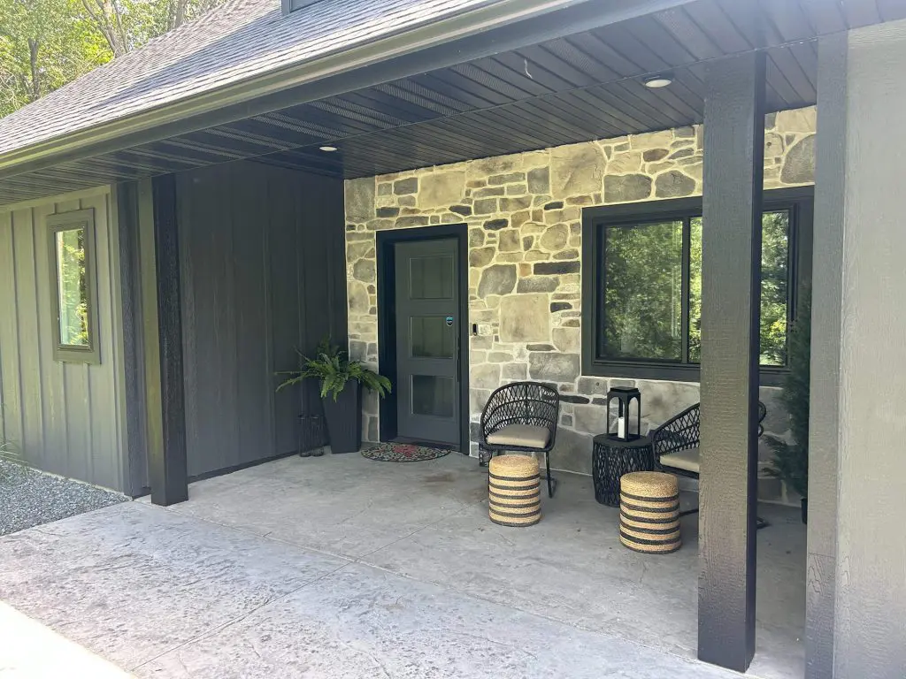 A modern outdoor space featuring a dark-stained wood structure and exterior, meticulously finished by Texas Star Painting of Austin.