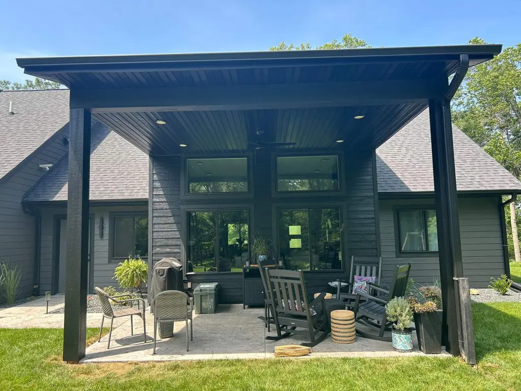 A striking, freshly painted black outdoor patio structure and siding, completed with precision by Texas Star Painting of Austin.