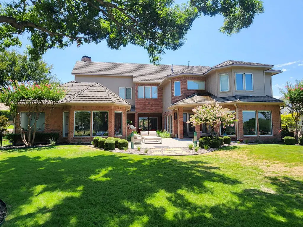 This sprawling backyard view of a magnificent home, complete with varied textures and trim, is a perfect canvas for Texas Star Painting of Austin.
