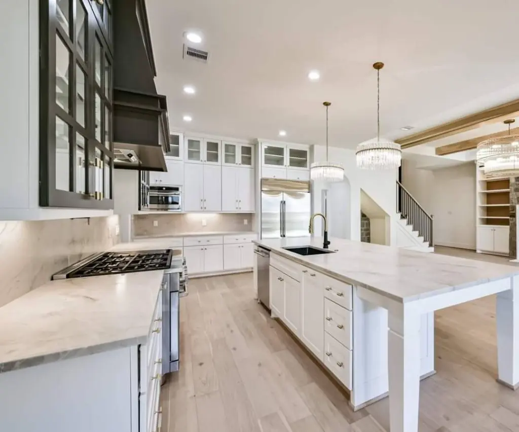 Wide-view shot showcasing the high-end, freshly painted luxury kitchen and entryway by Texas Star Painting of Austin.