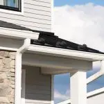 Home exterior trim and siding showing how weather affects exterior paint durability over time, including sun exposure and moisture around gutters and rooflines.