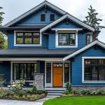 Blue two-story home with white trim and modern design illustrating what impacts the cost of exterior painting in Austin, including size, detail work, and materials.