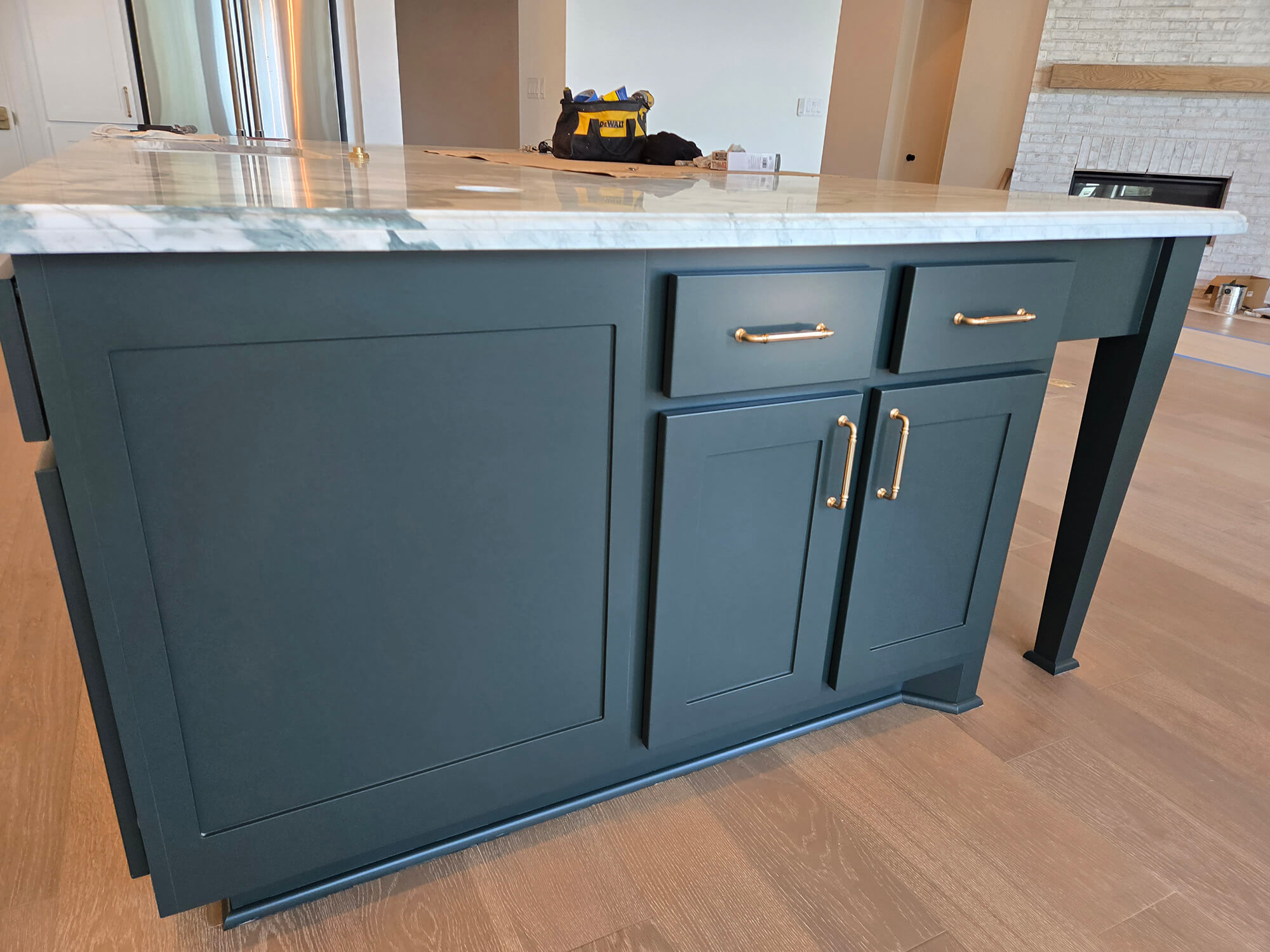 Built-in beverage bar with sophisticated matte black cabinetry, under-cabinet lighting, and a white marble top, completed flawlessly by Texas Star Painting of Austin.