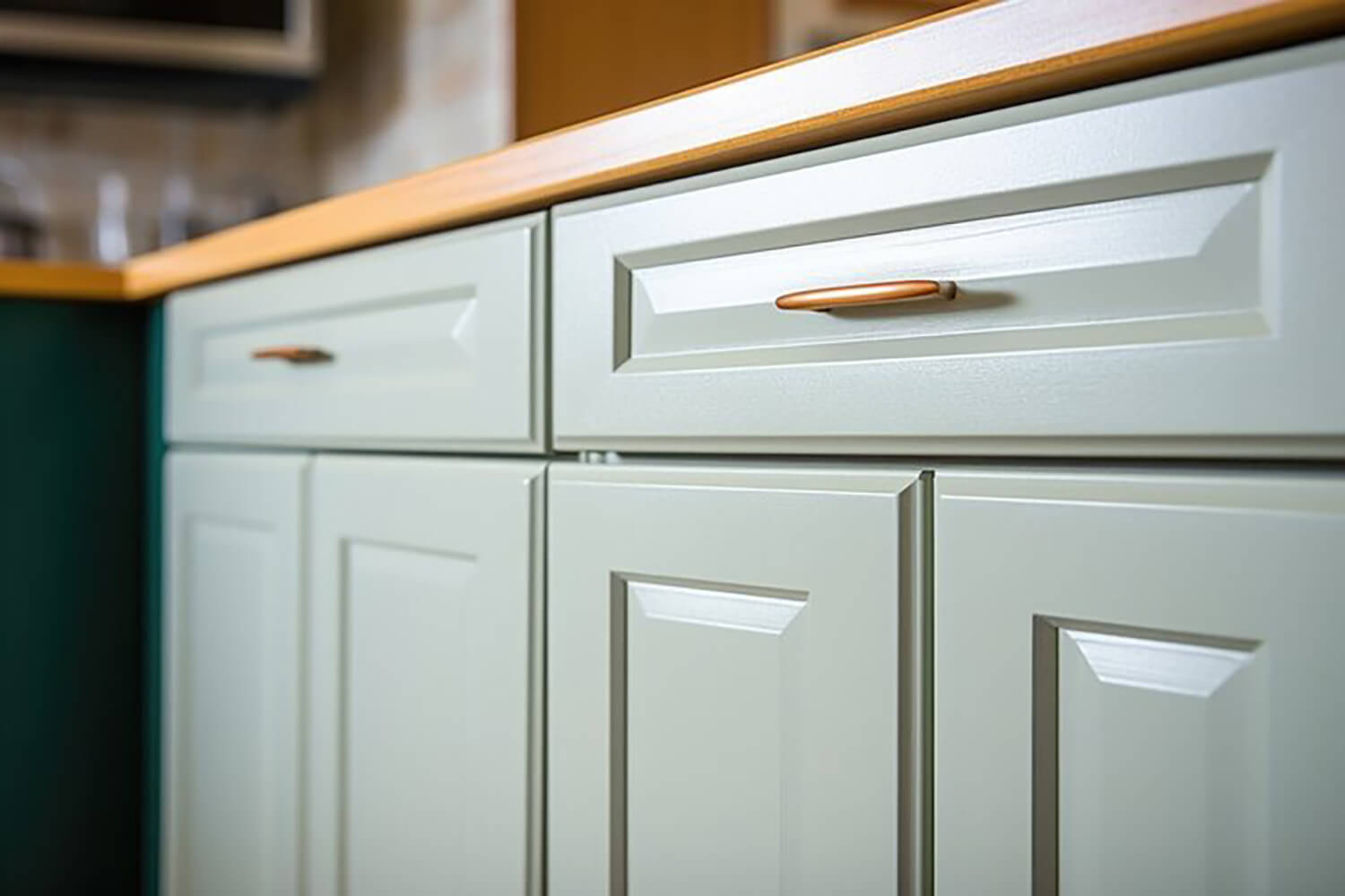 Freshly painted kitchen cabinets in a soft neutral finish, showing why is cabinet painting worth it for updating older kitchens