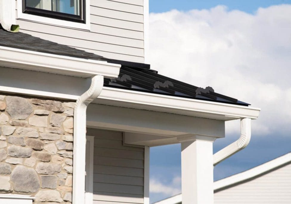 Home exterior trim and siding showing how weather affects exterior paint durability over time, including sun exposure and moisture around gutters and rooflines.