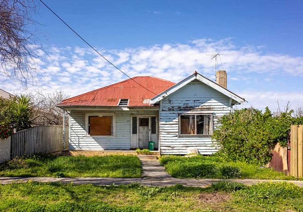 Signs your exterior paint is failing on an older home with peeling siding, flaking paint, and visible surface wear on the exterior walls